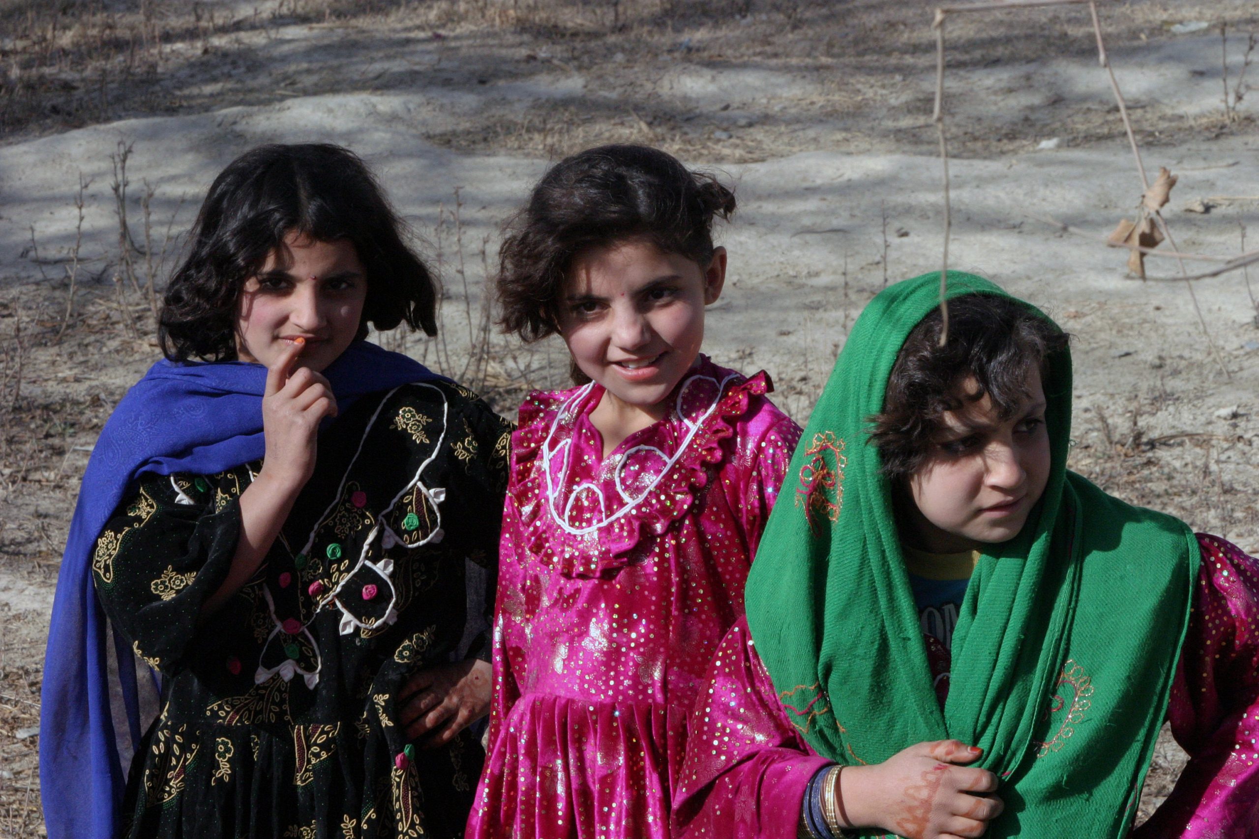 Three Afghan girls pose for the camera in the Khowst province of Afghanistan on December 1, 2004. during Operation ENDURING FREEDOM. 
(U.S. Marine Corps official photo by Corporal Justin L. Schaeffer) (Released)