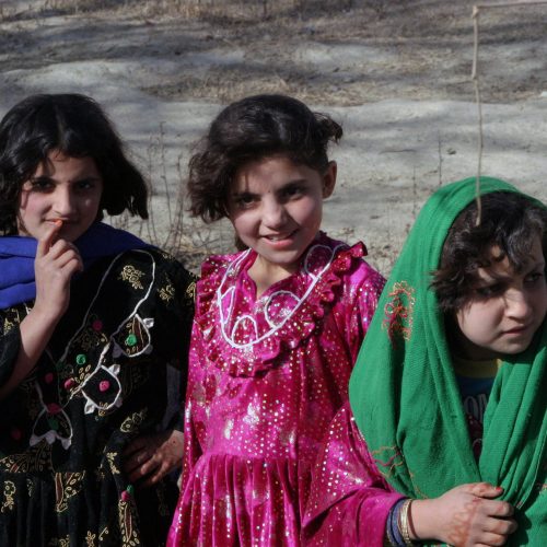 Three Afghan girls pose for the camera in the Khowst province of Afghanistan on December 1, 2004. during Operation ENDURING FREEDOM. 
(U.S. Marine Corps official photo by Corporal Justin L. Schaeffer) (Released)